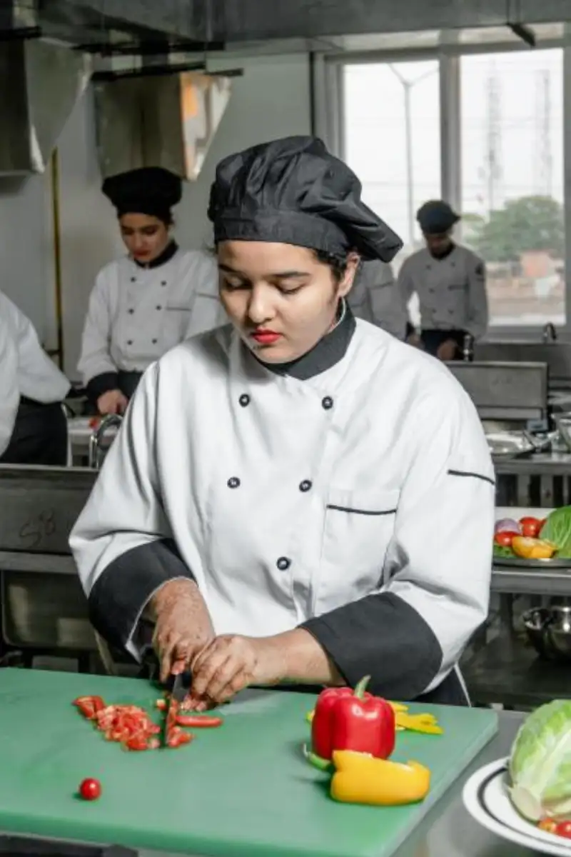Brightwood culinary student practising in the kitchen lab